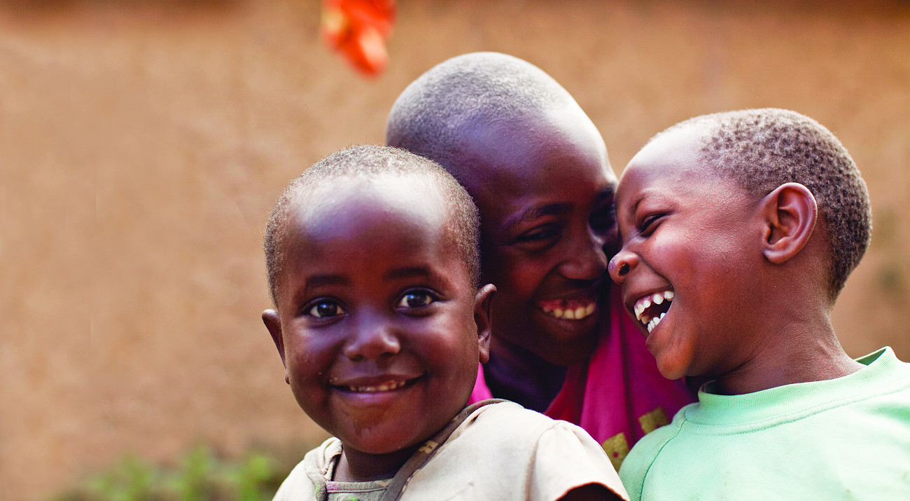 Three children laughing together