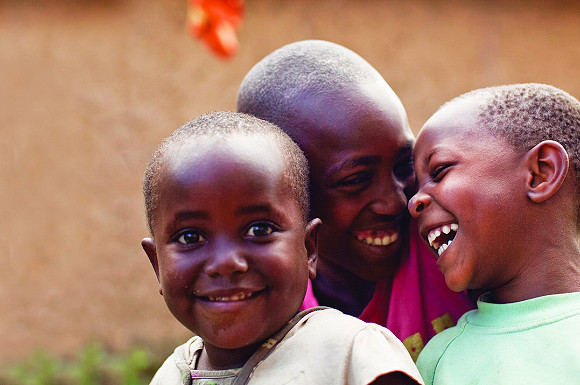 Three children laughing together